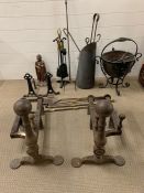 A large selection of fire side tools, buckets and a substantial pair of cast iron fire dogs