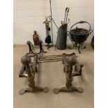 A large selection of fire side tools, buckets and a substantial pair of cast iron fire dogs