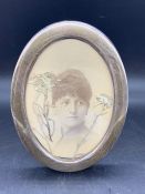 An oval hallmarked silver photo frame