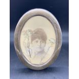 An oval hallmarked silver photo frame