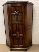 A oak hall cupboard/wardrobe with carved lion head decoration