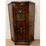 A oak hall cupboard/wardrobe with carved lion head decoration