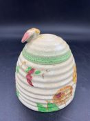 A hand painted honey pot by Clarice Cliff