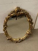 A gilt oval mirror