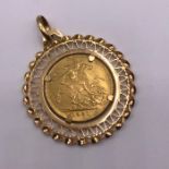 A 1931 Gold Sovereign in an 18ct gold mount (13.4g)