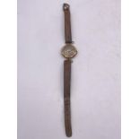 A 9ct gold ladies watch on a leather strap.