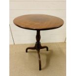 A mahogany tilt top occasional table on tripod legs (H68cm W60cm D60cm)