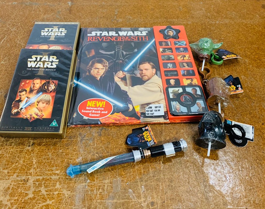 A selection of Star Wars collectables to include a book, dvd and keyrings etc