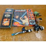 A selection of Star Wars collectables to include a book, dvd and keyrings etc