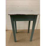 A small wooden unity table with metal lined top (H76cm W51cm D41cm)