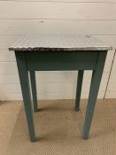 A small wooden unity table with metal lined top (H76cm W51cm D41cm)