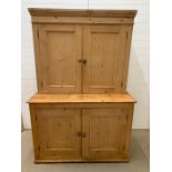 A Pine Pantry Cupboard with brass handles, both sets of cupboards are shelved (W 130cm x D 59 cm x H