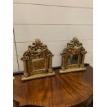 A pair of small gilt frame mirrors with cherubs (30cm x 25cm)