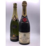 A Bottle of Moet champagne and a bottle of Pommery champagne.