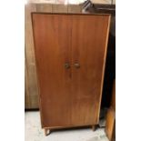 A Mid Century wardrobe with hanging space to side and shelves to other