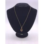 A 9ct gold Masonic pendant, on a 9ct gold neckchain with a boltring clasp. (2.5g)