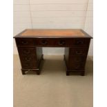 A Pedestal desk with orange leather top (W 122 cm x D 62 cm x 77 cm)