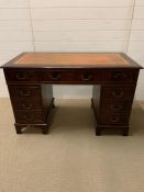 A Pedestal desk with orange leather top (W 122 cm x D 62 cm x 77 cm)