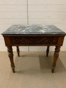 A Marble topped table on turned legs and central drawer with carved detail (H 75 cm x W 84 cm x D 56