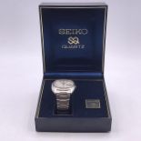 A Seiko Quartz watch in original box with paperwork.