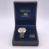 A Seiko Quartz watch in original box with paperwork.