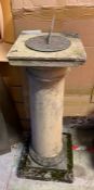 A garden stone sundial on column base