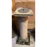 A garden stone sundial on column base