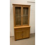 An oak display cabinet with cupboard under (W97cm D45cm H210cm)