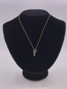 A Diamond set two stone pendant with a gold neckchain on a bolt ring clasp detailed 375.(Total