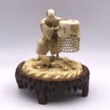 A 19th Century Ivory Figure of a man with chickens and chicken basket, signed to base.