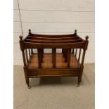 A mahogany Canterbury magazine rack on brass castors and dummy drawer