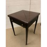 A cherry wood card table