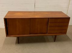 A Mid Century Sideboard with sliding cupboards and four drawers (H74cm W150cm D47cm)