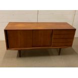 A Mid Century Sideboard with sliding cupboards and four drawers (H74cm W150cm D47cm)