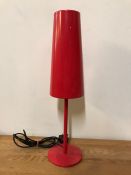 A lantern style contemporary table lamp in red