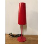 A lantern style contemporary table lamp in red