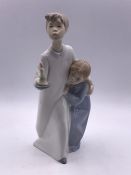 A Lladro figure of boy and a girl