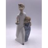 A Lladro figure of boy and a girl