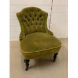 An olive button back bedroom chair on turned legs and castors (H70cm W56cm)