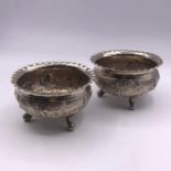 A pair of Persian silver salts or bowls on three legs.