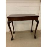 A Card Table on ball and claw feet, with brass corner holders.