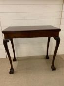 A Card Table on ball and claw feet, with brass corner holders.