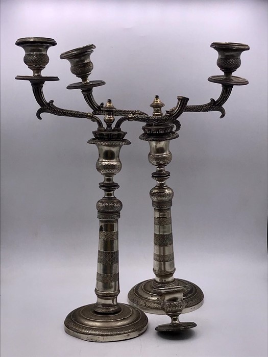 A Pair of silver plated candlesticks