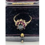 A 9 ct gold ring with garnets.(Total weight 2.1g)