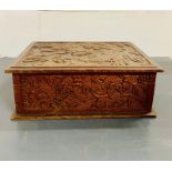 A Chinese carved box with grapes and vines to side.