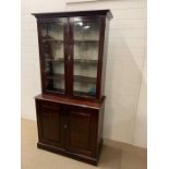 A glazed mahogany bookcase with cupboard under (H201cm W100cm D47cm)