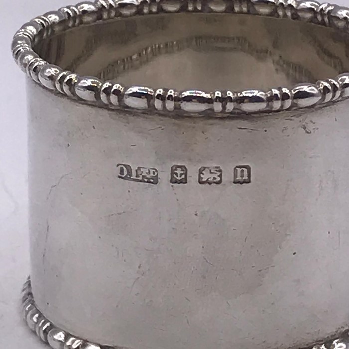 A small selection of silver items to include two thimbles, a napkin ring and fork - Image 3 of 6