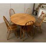 A blonde Ercol dining table of oval design and five chairs 120cm Dia x 73cm H