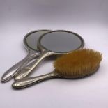 Three white metal Ladies vanity items to include two mirrors and a brush.