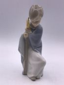 A Lladro figure of a child with a Scaff